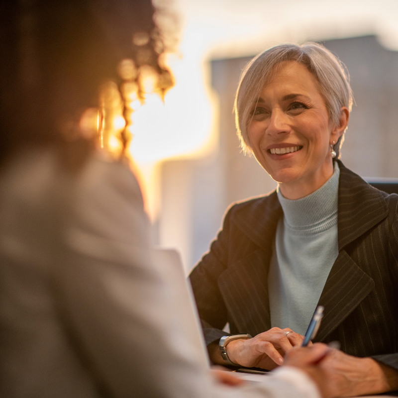 A middle aged woman meets with an advisor