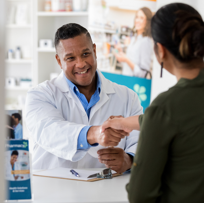 Pharmacist smiles at client